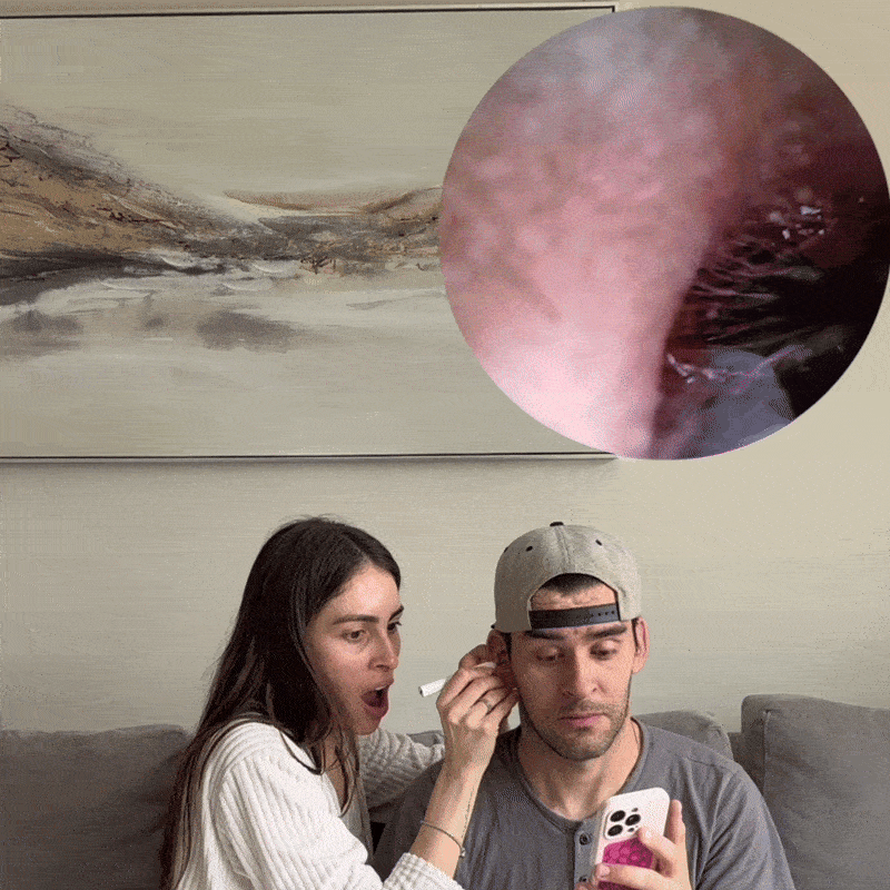 Person cleaning someone's ear with a magnified inner ear view inset.