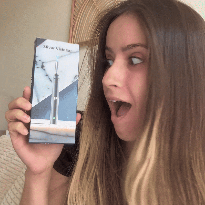 Person looking surprised at a Slivor VisioEar product box.